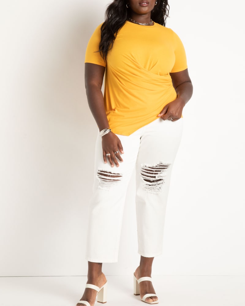Front of a model wearing a size 14|16 Draped Tee With Asym Hem in Golden Glow by ELOQUII. | dia_product_style_image_id:284393